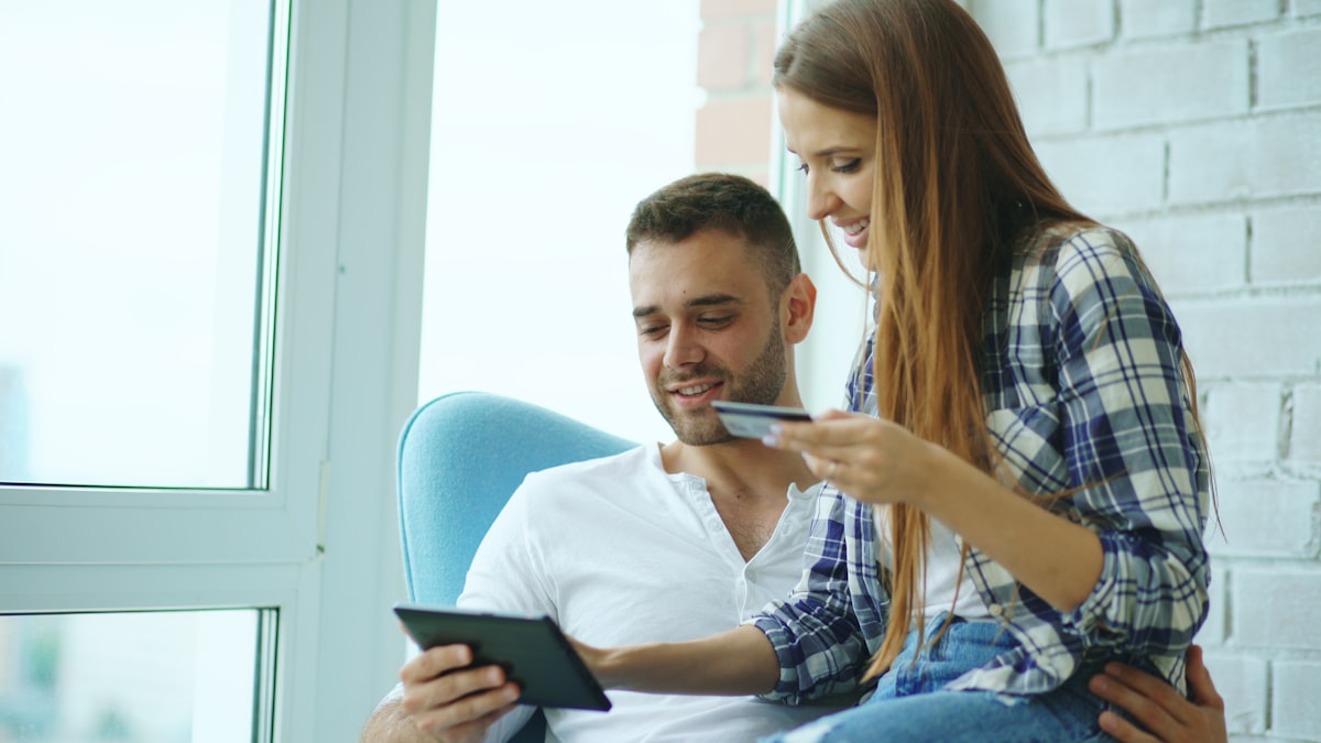 Couple reviewing credit card options on laptop
